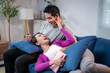 © Apichat - A man and a woman are laying on a couch