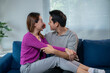 © Apichat - A man and a woman are sitting on a blue couch