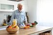 © Jelena Stanojkovic - Salad and old man cooking food for a healthy dinner dish with fresh organic green vegetables and eggs. Senior, kitchen and hungry elderly person cutting ingredients for a lunch diet in a house.