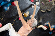© JackF - Sporty elderly female exercising in boulder climbing hall without rope, reaching new results, enjoying new challenges in amusement park