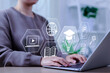 © Sandwish - Online education and e-learning concept. A person use a laptop with icons representing online education, learning, knowledge sharing, educational tools, training, webinar on internet, digital courses,