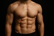 © Boke - Bodybuilder showing his defined abdominal muscles on dark background