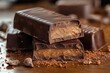 © Margarita - Close-up of chocolate bars with creamy filling on a wooden surface scattered with cocoa powder and cocoa beans