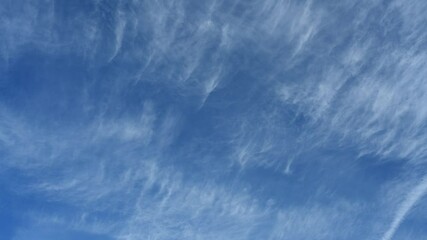Wall Mural - Timelapse of streaky cirrus clouds moving across a bright blue summer sky
