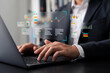 © Thapana_Studio - Businessman analyzing digital data analytics dashboard on laptop with futuristic graphs and charts, representing modern business intelligence, statistics, and financial technology.
