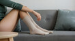 © Diana - Relaxing Moments Woman's Legs in Cream Socks on a Gray Sofa