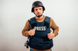 © karrastock - Reporter in bulletproof vest with a camera.