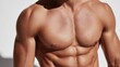 © Blackmint Studio - A well-defined torso showcases impressive muscles with a focus on the chest and abs, illuminated by natural light in a simple, clean setting, emphasizing strength and fitness