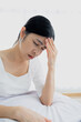 © Ton Photographer4289 - Young woman touching her temples with her hand because of severe headache due to stress or migraine. Health and mental health problem concept..