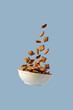 © Cavan Images - Levitating bowl with chocolate pads cereals nougats, breakfast