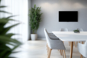 Poster - Modern meeting room interior with white table, gray chairs, potted plant, wall mounted screen, and natural light creates calm atmosphere