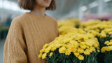 Yellow chrysanthemums harmonize with a woman's cozy ochre sweater, embodying autumn equinox whispers and Diwali's vibrant soul