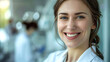 © DP - Smiling woman in a white lab coat stands confidently in a laboratory setting, showcasing professionalism and dedication to her scientific work and research environment