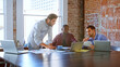 © Monkey Business - Multi-Cultural Group Of Businessmen Working Together Using Laptops In Boardroom