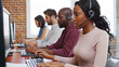 © Monkey Business - Multi-Cultural Business Team Wearing Headsets Working In Busy Customer Service Department