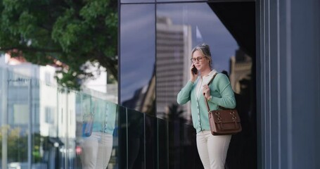 Poster - Office, building and woman with phone call in city for rental negotiation, auction planning or networking. Real estate agent, employee and speaking to contact on rooftop for property lease discussion