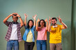 © StockImageFactory - Indian university group shows thumbs up and heart gesture while cheering and celebrating indoors