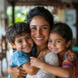 © Marta  Maksymiv - Portrait of mom and children at home-mom hugging hers two children in the living room of her house-single mother with her children-happy little family-Hispanic family