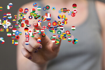 Poster - Image of a hand interacting with floating flags representing global connection and international collaboration.