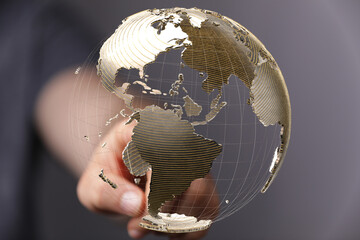 Leinwandbilder - Abstract image of a hand interacting with a digital globe, representing global connectivity and networking.