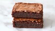 © Watcharaphon - National brownie day with homemade chocolate idea. Delicious chocolate brownies stacked together on a surface.