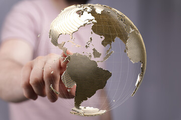 Fototapete - A hand points at a digital globe, symbolizing global connections and networking.