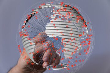 Fototapete - A hand interacts with a 3D model of Earth, showcasing interconnected data points across the globe.