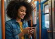 © Laki - Smiling woman using smartphone while riding public transportation