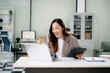 © Nuttapong punna - Asian business woman are delighted and happy with the work they do on their tablet, laptop and taking notes
