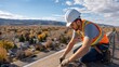 © isz - Roofer Working on a Residential Roof with Scenic Mountain View
