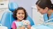 © Ajronujen - Young girl smiling while sitting in dentist chair with teddy bear