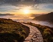 © Andrea - winding stone pathway leads through misty mountain landscape at sunrise with dramatic clouds and golden light illuminating foggy valley below