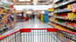 © StephanK - Close-up of Red Shopping Cart Handle in Supermarket Aisle with Blurred Shelves and Colorful Product Background – Retail and Grocery Store Concept