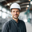 © kora studio - confident man wearing hard hat smiles in industrial setting, his professionalism and readiness for work. background features modern workspace with natural light