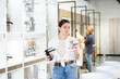 © JackF - Female customer choosing faucet or spigot combination set for water supply