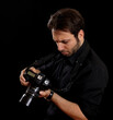 © Antonio Gravante - Photographer reviewing photos on camera with disappointed expression