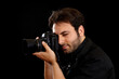© Antonio Gravante - Photographer framing a shot with professional camera on black background