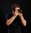 © Antonio Gravante - Photographer taking photos with professional camera in studio with black background