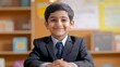 © Valeri - Joyful Indian boy in neat school uniform celebrating knowledge day in classroom on September 1