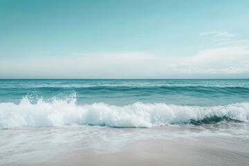 Wall Mural - Turquoise waves crash gently on a serene shoreline under a clear blue sky, Turquoise waves crashing on serene sea under clear sky