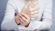 © Oporty786 - Woman hand pain wrist injury healthcare closeup holding discomfort woman white shirt holds her painful wrist showing