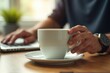 © Ева Поликарпова - A person enjoying their morning coffee at a table
