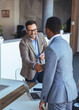 © Dragana Gordic - Businessmen Shaking Hands During a Meeting Inside a Modern Office Setting