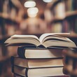 © DDU - Photo of an Open Book on Stack of Books in a Library with Blurred Shelves in Background
