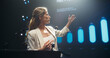© Gorodenkoff - Empowering Female Company CEO Delivering a Positive Earnings Report at a Shareholders Event. Public Speaker Sharing Statistics, Future Goals and Leadership Insights to the Guests in the Room