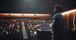 © Gorodenkoff - South Asian Software Developer Using Laptop Computer and Delivering a Motivational Speech on Stage, Hosting a Seminar to Help Entrepreneurs Overcome Their Personal and Professional Challenges