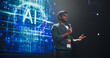 © Gorodenkoff - Portrait of an Indian Speaker Coaching Specialists During a Presentation at a Business and Technology Conference. Businessman Showing a Futuristic Tech Presentation About AI and LLM Systems