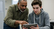 © Firdaus - Older Man and Young Boy Using Tablet in Indoor Setting