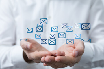 Poster - Image of hands holding a network of email icons, representing global communication.