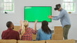 © Monkey Business - Group Of Friends Playing Computer Game On Green Screen TV With Virtual Reality Headset